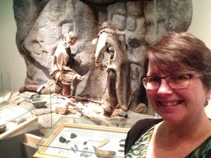 Standing in front of the replica of the Fleur de Lys soapstone pot wall at the Rooms.